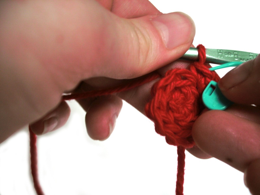 Adding a stitch marker to the front loop of the last stitch in a crochet round.