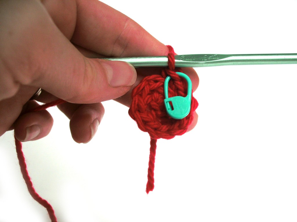 small crochet circle with stitch marker attached to the last stitch