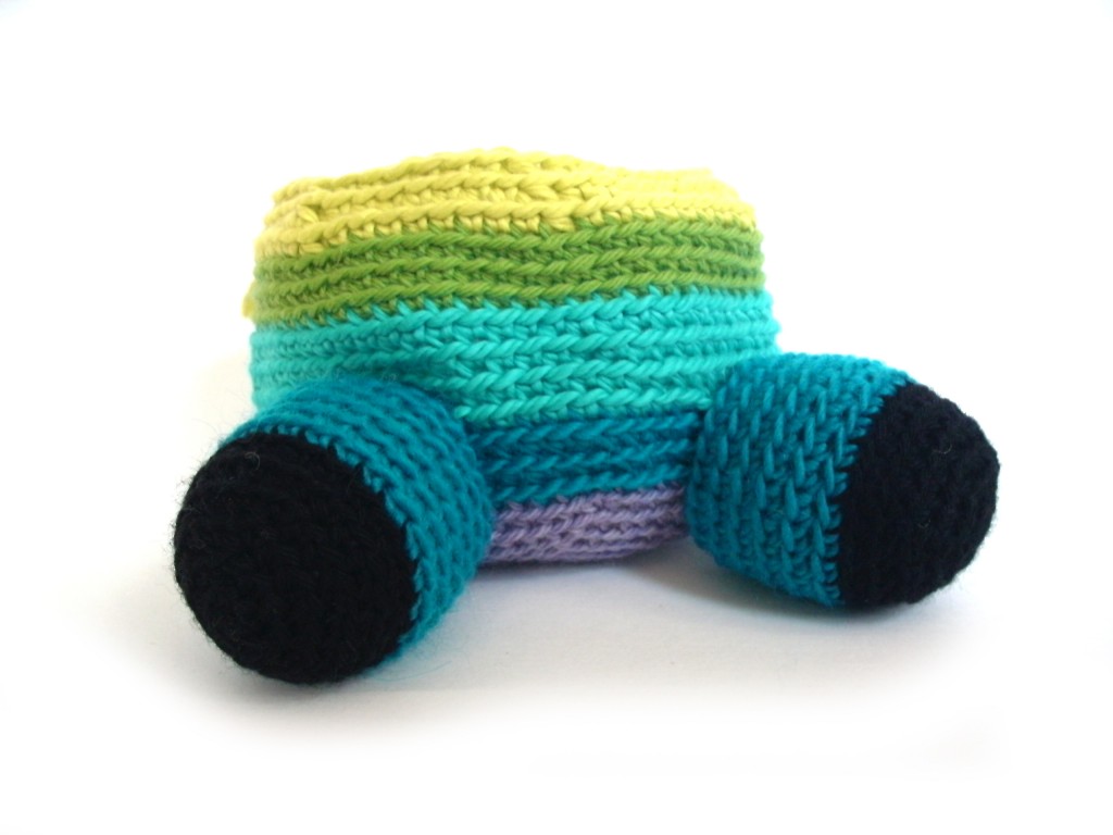 partially crocheted softie body with two legs - demonstration showing how to attach limbs with whipstitch
