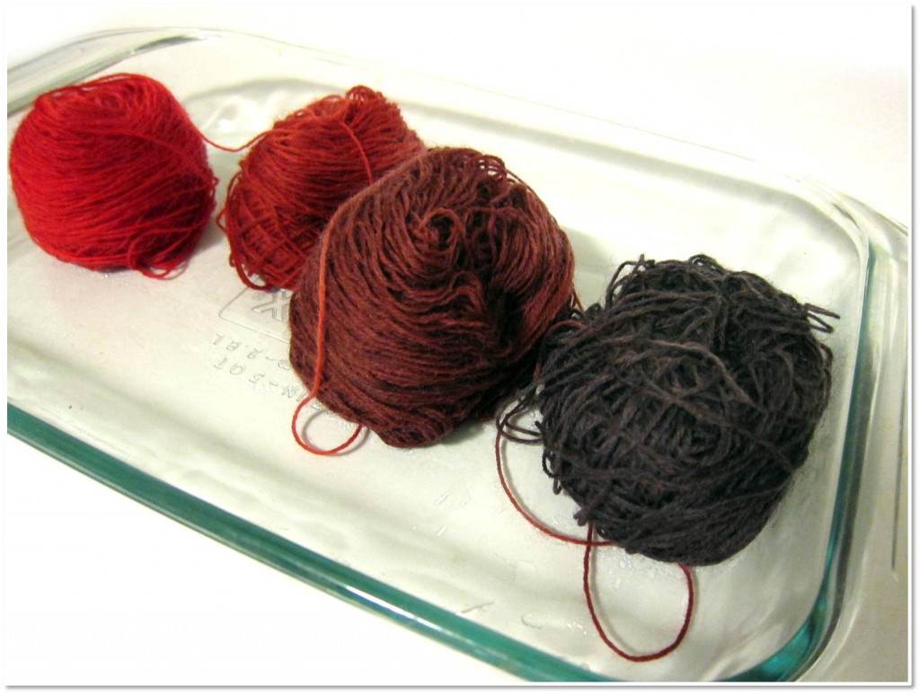 How to dye gradient yarn - four balls of yarn each dyed a different color, shading from red to deep purple