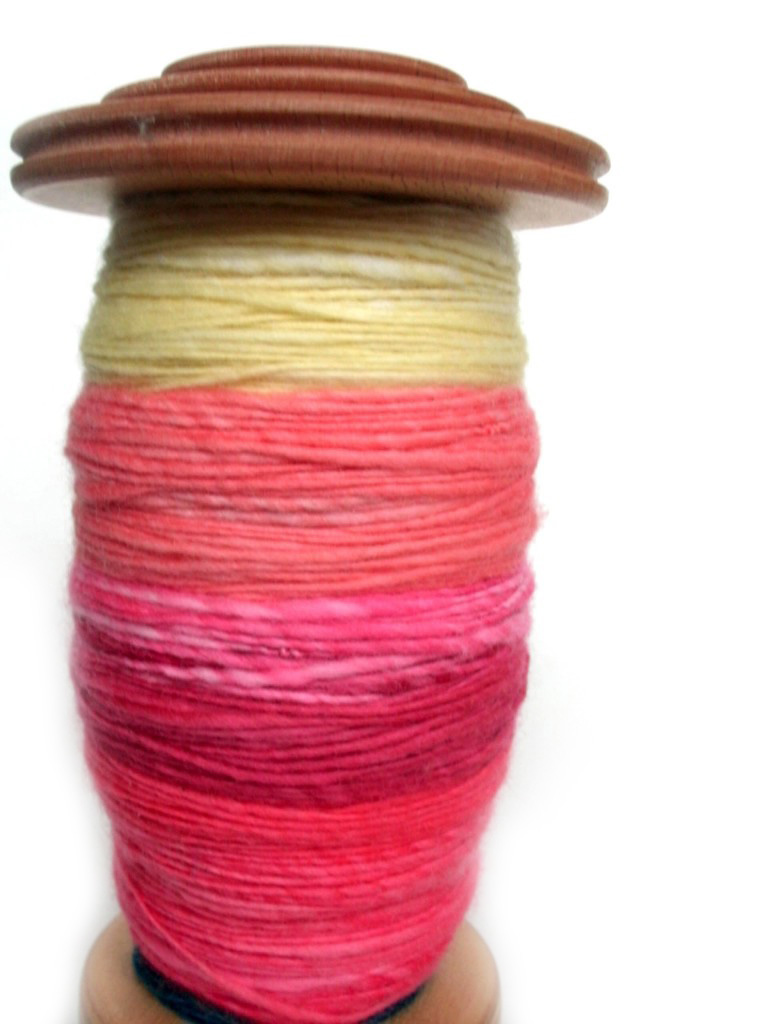 spinning yarn on bobin yellow red